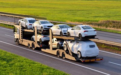 Car,Carrier,Trailer,Transports,Cars,On,Highway,On,Sunset,Background.